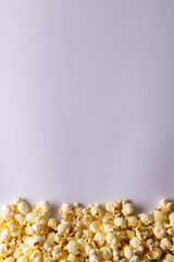Vertical image of pop corn lying on white background