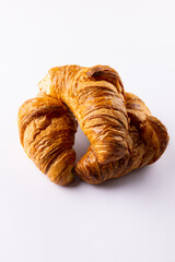 Vertical image of croissants lying on white background