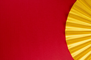 Composition of traditional chinese fan on red background