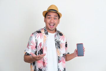 Asian man wearing beach shirt showing empty handphone screen with excited expression