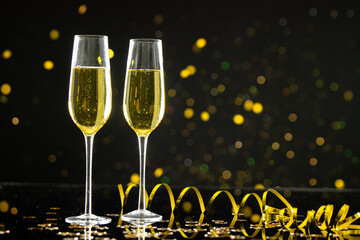 Composition of close up of new years champagne on black background