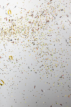 Composition of close up of new years confetti on white background