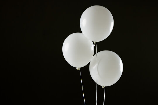 Composition of close up of new years balloons on black background