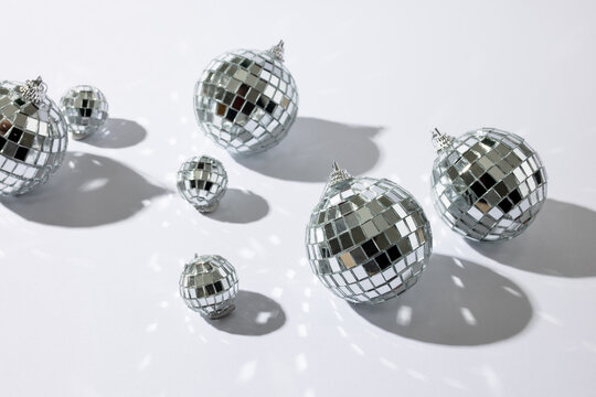 Composition of close up of new years baubles on white background