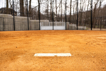 View of typical nondescript high school softball clay infield looking from pitching rubber toward...