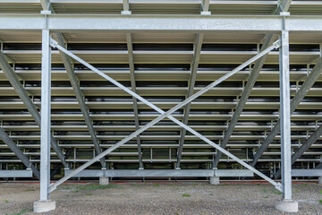 Straight on view of under stadium bleachers, steal I-Beam bleachers with X cross brace, with stone...