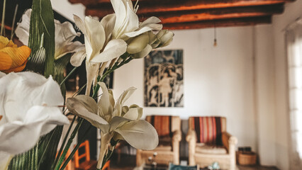 flower detail. beautiful architecture, artistic paintings, sackcloth armchair and wooden ceiling