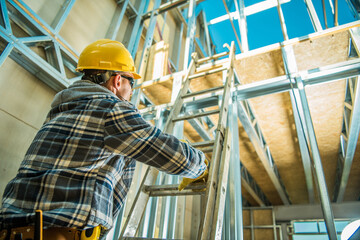 Contractor Climbing the Ladder at Construction Site © Tomasz Zajda