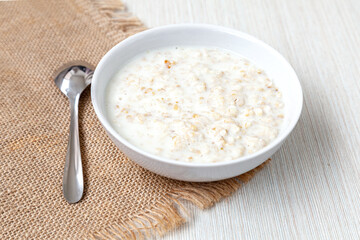 Plate with oatmeal - light background