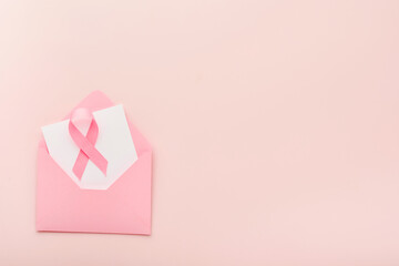Pink Breast Cancer Awareness Ribbon. Pink envelope with ribbons on backgrounds. Breast cancer awareness and October Pink day, world cancer day. Top view. Mock up.
