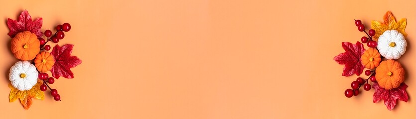 Autumn bouquet of acorns, berries, maple leaves, pumpkins isolated on orange background Flat lay Top view Floral border Holiday card Hello September, October, November concept