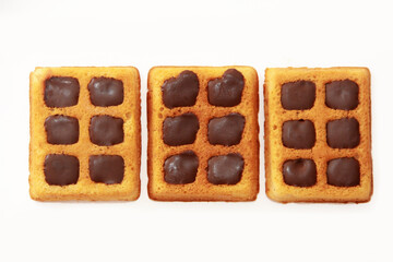 sweet baked fluted Belgian waffles with chocolate filling on a white background