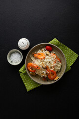 Risotto with mussels and shrimps cheese in bowl  top view italian food on black surface