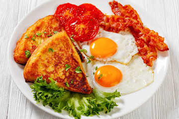 irish breakfast of fried eggs, bacon, potato farls
