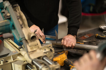 Repairman repair motorcycle, maintenance in garage. Mechanic fixing bike in a modern shop