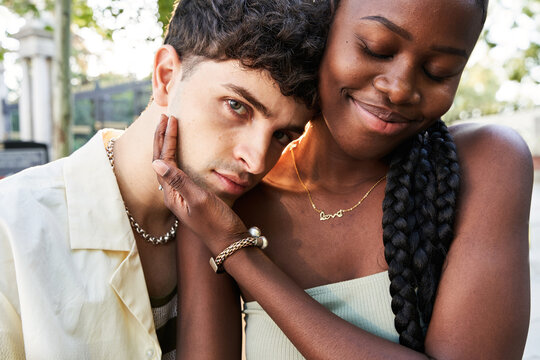 Black woman touching face of boyfriend