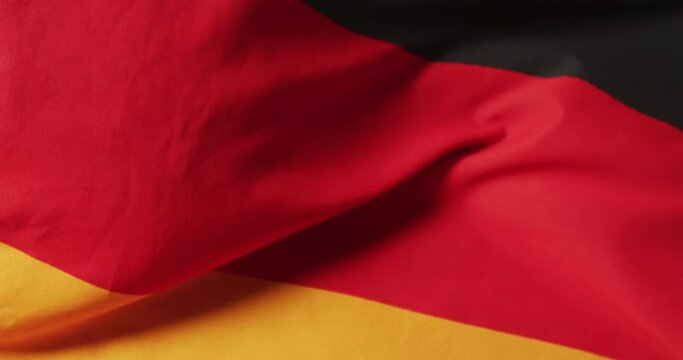 Animation of football over flag of germany with copy space