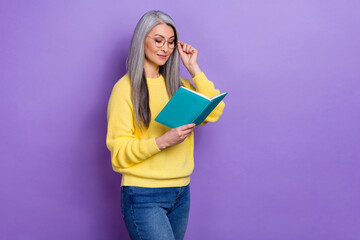 Photo of clever pretty lady pensioner dressed pullover arms eyewear reading fiction literature...