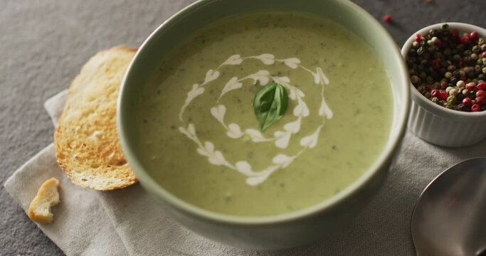 Video of green peas soup and ingredients lying on grey surface