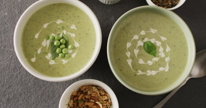 Video of green peas soup and ingredients lying on grey surface
