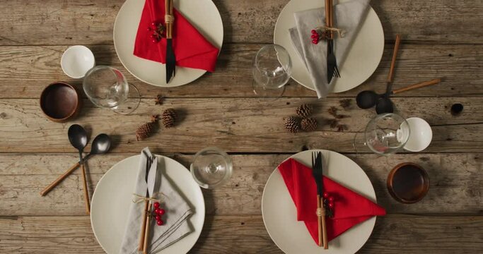 Video of plates with cutlery and glasses on wooden surface
