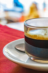 Glass Cup of black coffee in a restaurant Phuket Thailand.