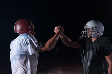 two american football players face to face in silhouette shadow on white background