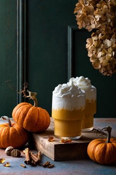 Spicy pumpkin latte with whipped cream. Autumn or winter hot coffee drink with cinnamon, nutmeg