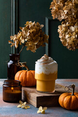 Spicy pumpkin latte with whipped cream. Autumn or winter hot coffee drink with cinnamon, nutmeg