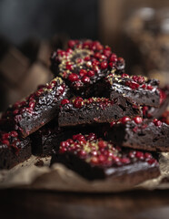 Brownie chocolate with berries on dark background 