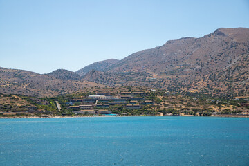 Turquoise blue sea panoramic view with a mountain in the background