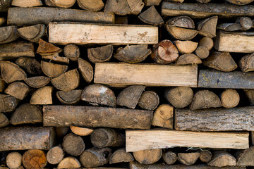 Texture of logs, firewood stacked in an old house in the Pyrenees