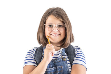 Smiling cute young schoolgirl in glasses holds pencil close to her mouth