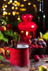 Obraz na płótnie Canvas Mulled wine in a red mug on the autumn table