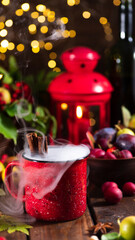 Mulled wine in a red mug on the autumn table