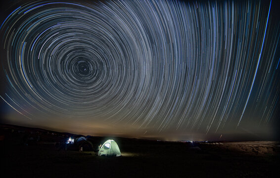 Star trails over noght desert camp
