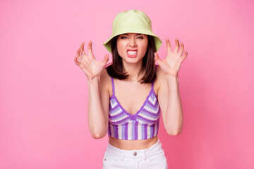 Closeup photo of young creepy lady wear funny cap grimacing frightening halloween face hands isolated on pink color background