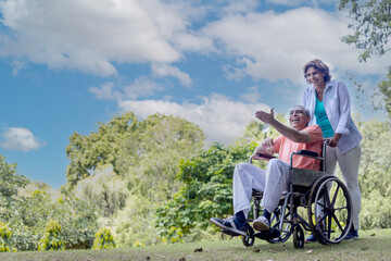 physically challenged man on wheel  chair with woman 