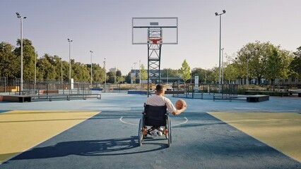 Disabled man in wheelchair improves basketball skills