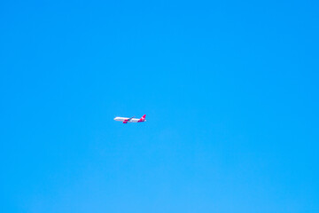 Naklejka na ściany i meble Blue sky with a small plane