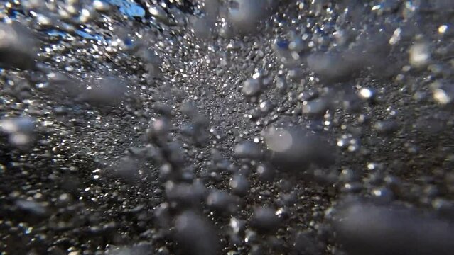 Under water Super slow motion of tide going back out to sea. Crystal clear water. Millions of bubbles rushing passed the camera with amazing fluid motion