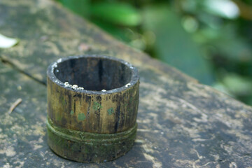 Naklejka premium Close up view of handmade ashtray. Ashtray made of bamboo.