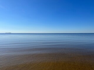 Quiet sea horizon, transparent sea water, sandy beach, blue sky