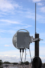 radio relay antenna on the roof with sky on background