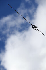 Obraz premium old metal spiral antenna on sky background