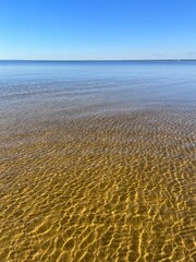Quiet sea horizon, transparent sea water, sandy beach, blue sky