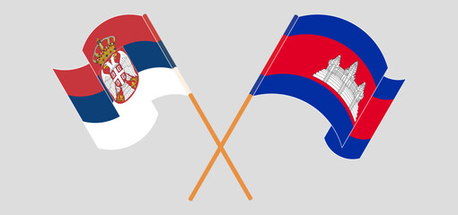 Crossed and waving flags of Serbia and Cambodia