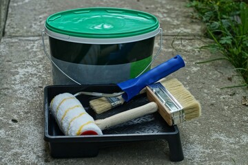 a roller for painting walls and a floor with two hand-held counters lie in a black plastic...