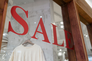 sign of sale on shopping mall window