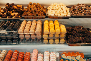 Shop of sweets full of delicious colourful macaroons, marmalade, chocolate and biscuits.